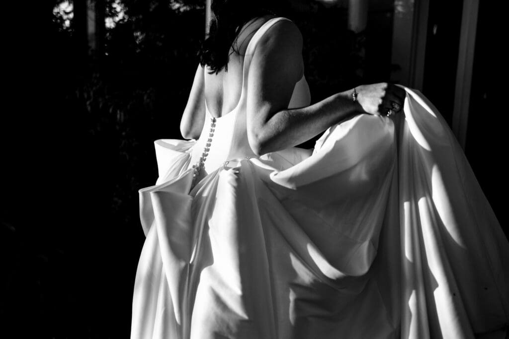 Black and white photo of the back of the bride's dress