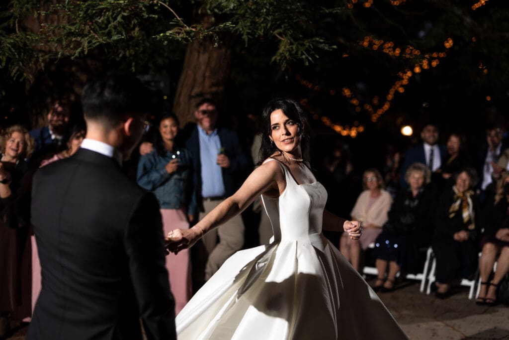 Bride holding her groom's hand for their first dance at their Vine Hill House wedding