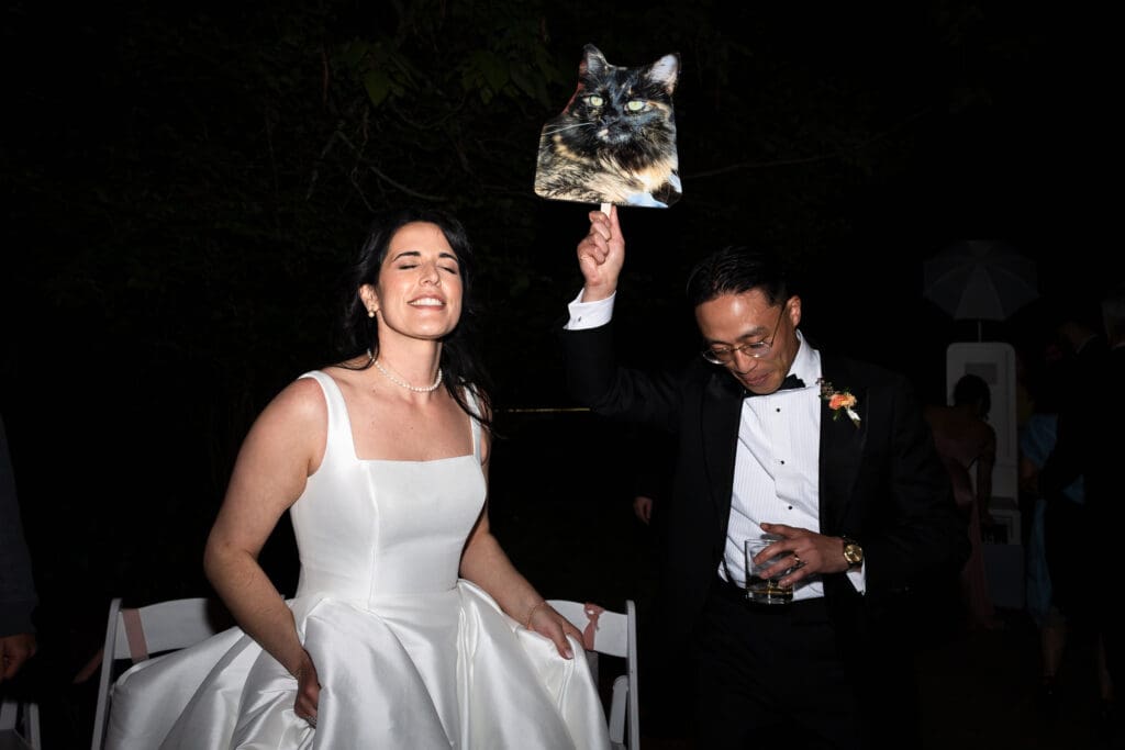 Bride and groom holding up photos of their cat at their Sonoma County VA wedding