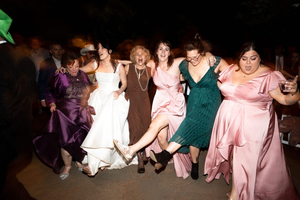 Wedding party and guests dancing to a fun song at Vine Hill House wedding