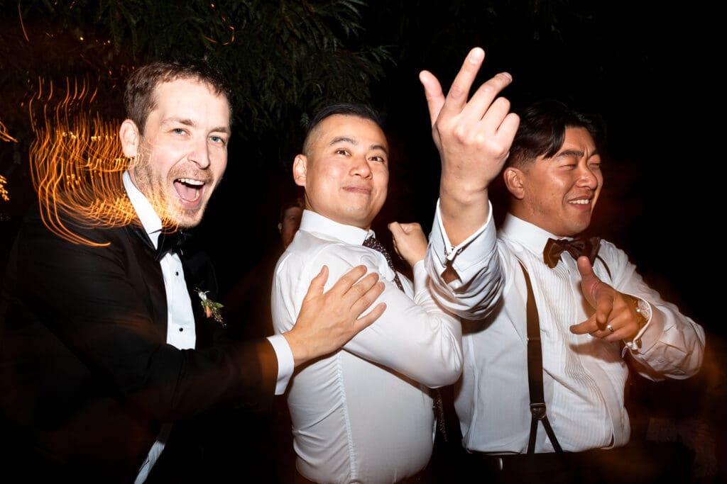 Groomsmen and wedding party singing and dancing at Sonoma County wedding reception