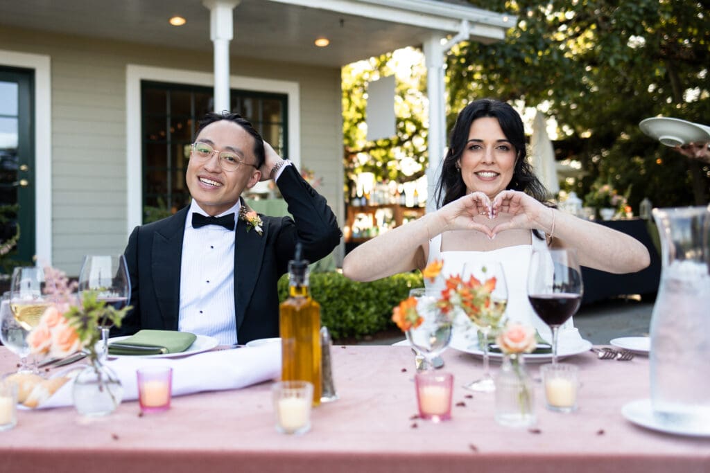 Bride and groom seated at their table at Vine Hill House wedding