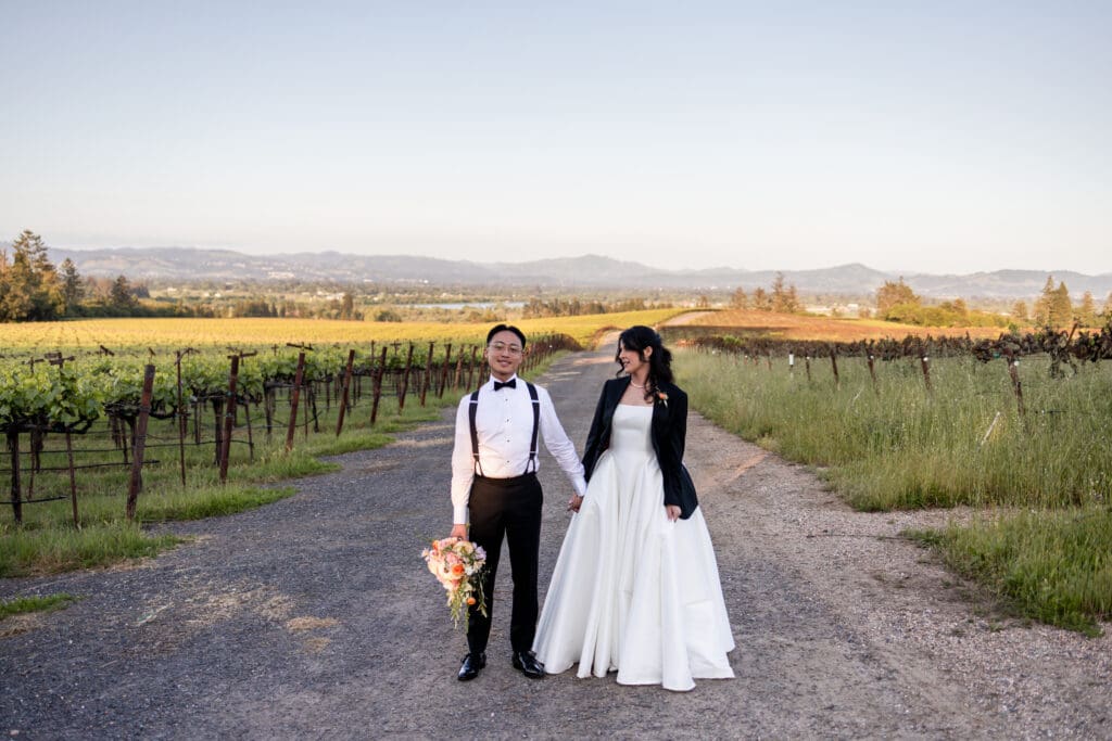 Bride and groom holding hands during sunset photos in Sonoma County