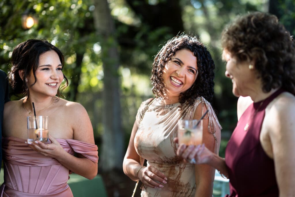 Wedding party and guests smiling and laughing before wedding at Vine Hill House