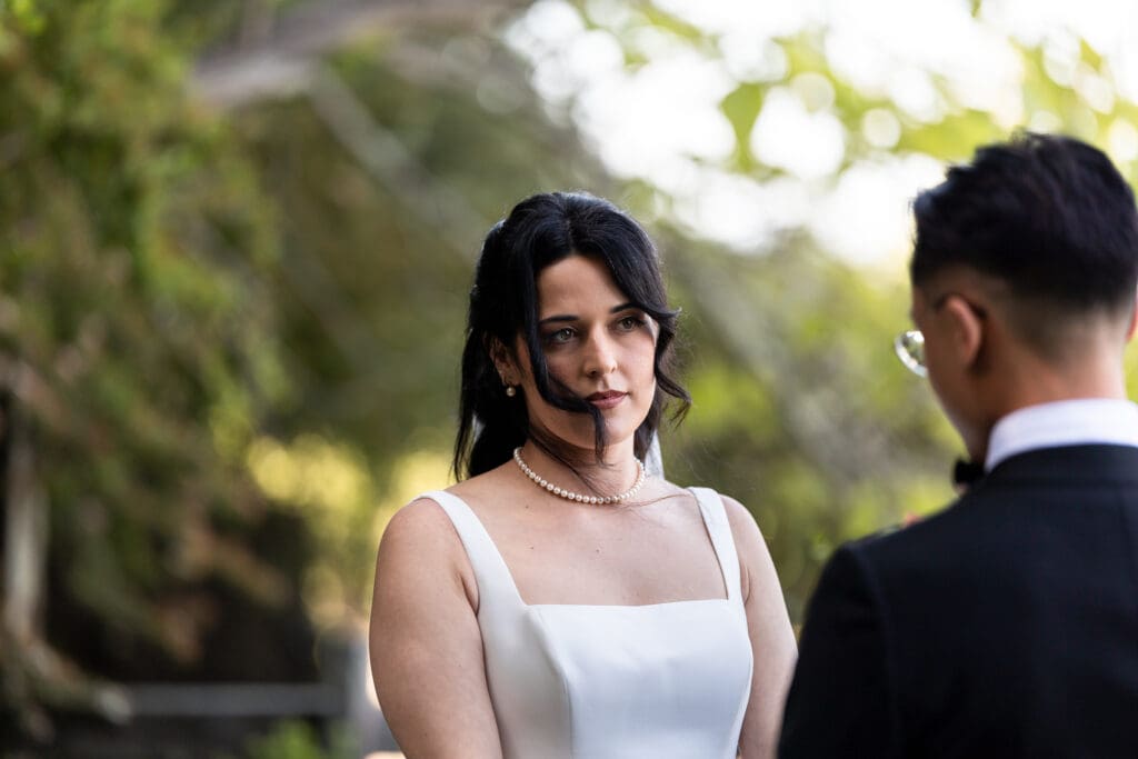 Bride looking at the groom as they exchange vows in outdoor Sonoma County wedding