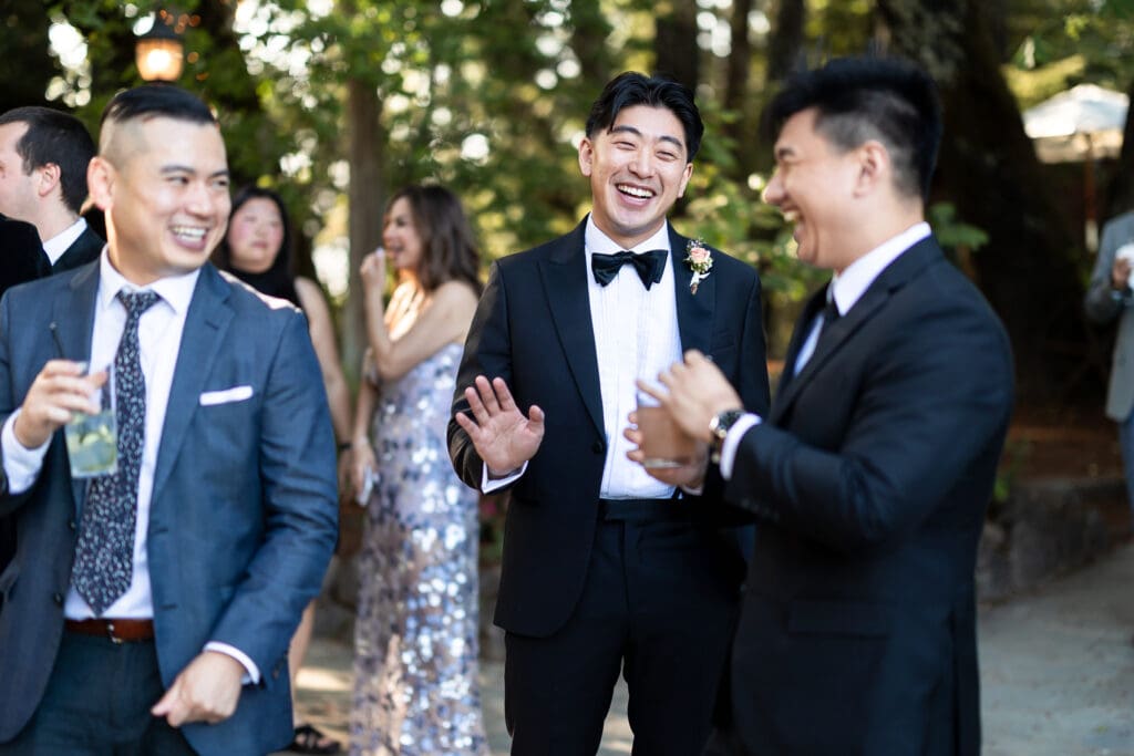 Wedding guests laughing before wedding ceremony in Vine Hill House wedding