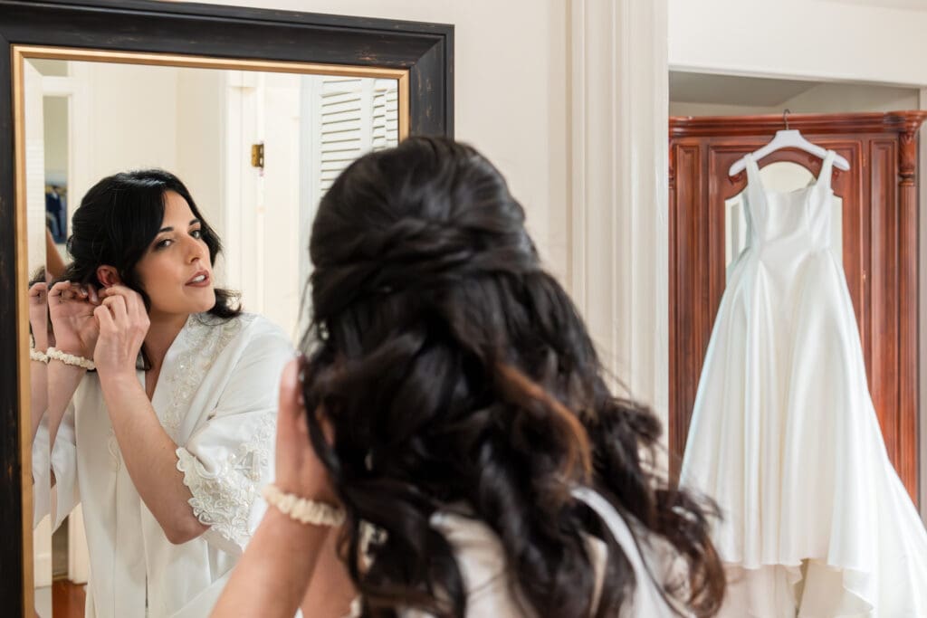 Bride adjusting earring in the mirror for Sonoma County wedding