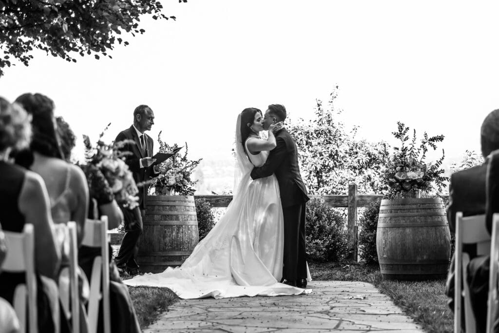Black and white photo of the first kiss at the Vine Hill House wedding ceremony