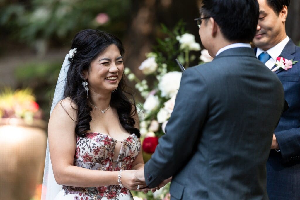 Bride laughing during wedding ceremony at Nestldown