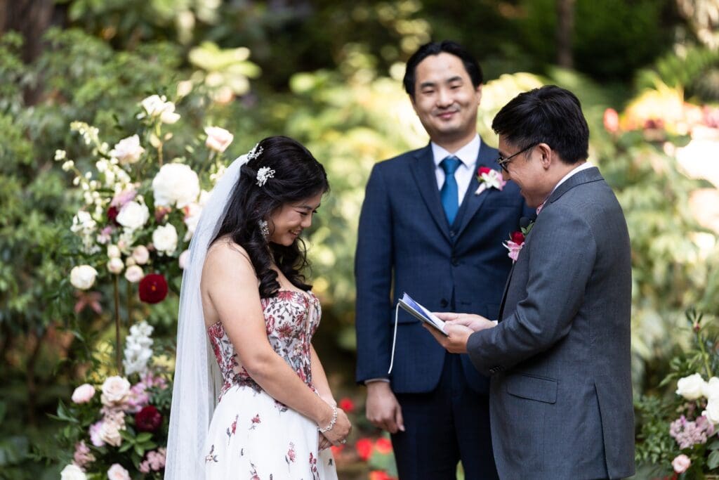Bride listening to wedding vows from her husband at Nestldown wedding