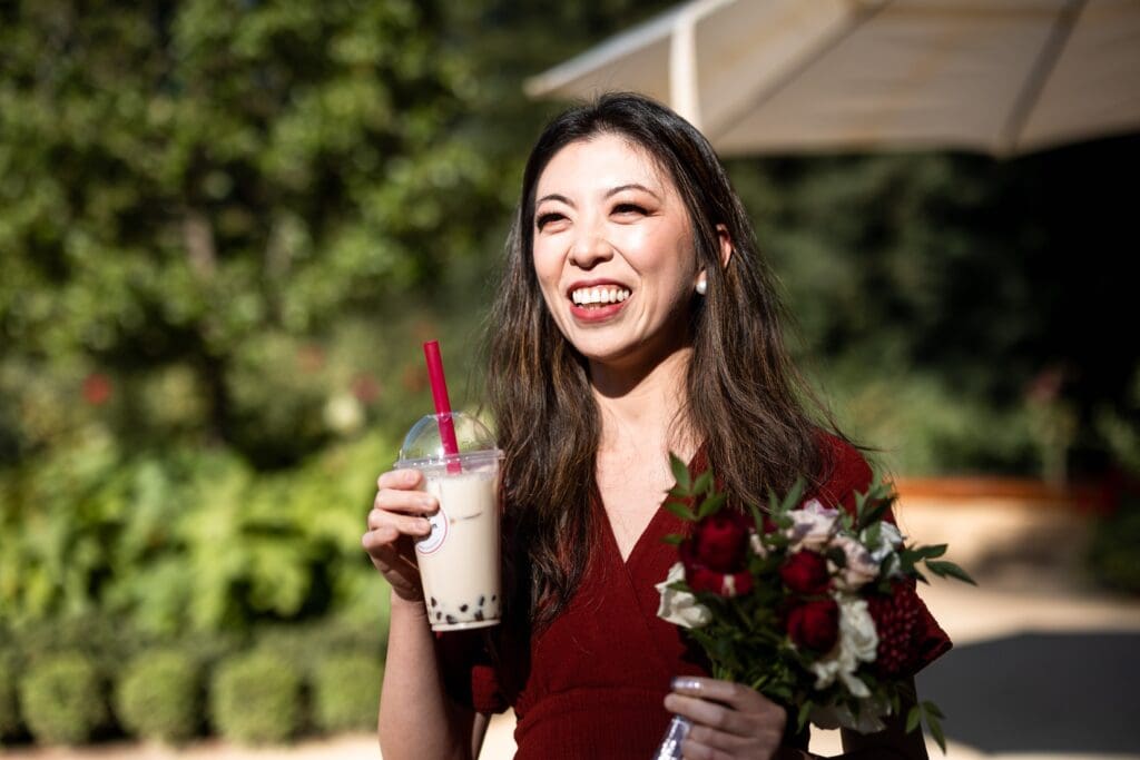 Wedding guest holding boba drink at Nestldown wedding