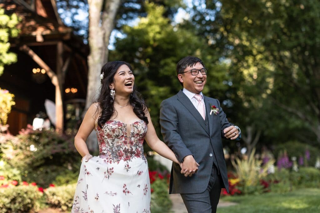 Bride and groom walking in hand-in-hand to wedding reception together
