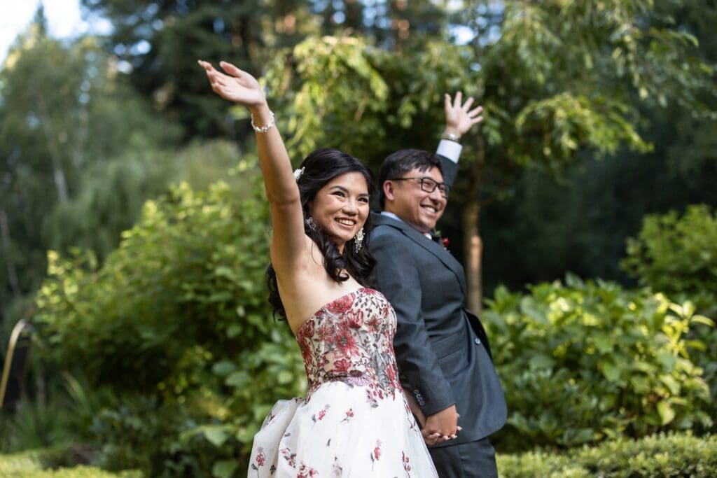 Bride and groom waving at wedding reception entrance at Northern California wedding
