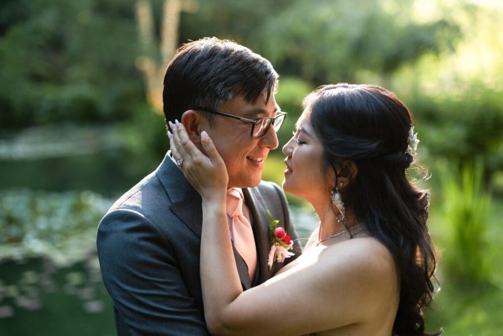 Bride and groom smiling and holding each other in a close up photo