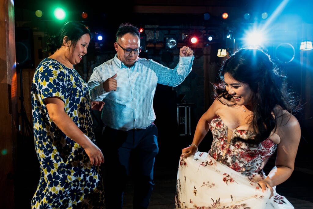 Bride dancing with two wedding guests at Nestldown wedding reception