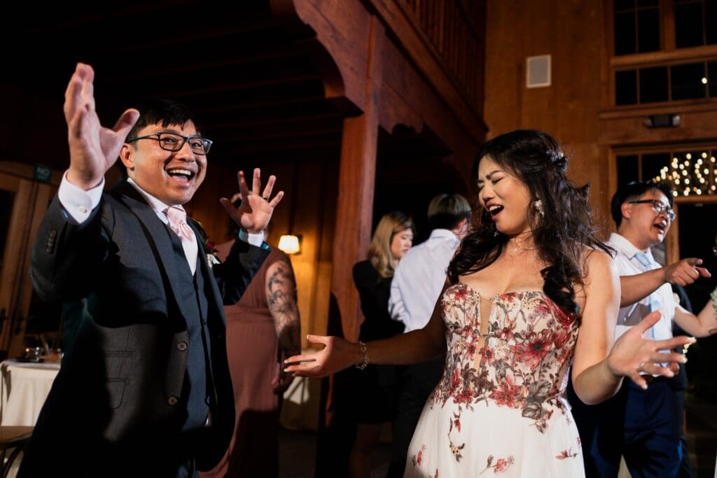 Bride and groom laughing and dancing at wedding reception in Nestldown