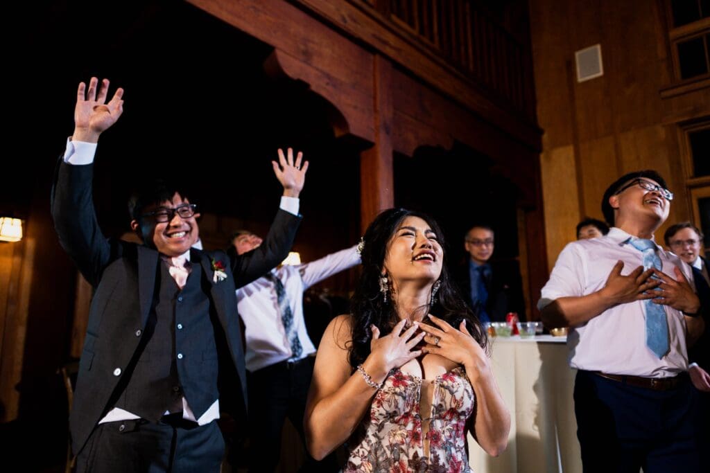 Bride and groom laughing and dancing at wedding reception