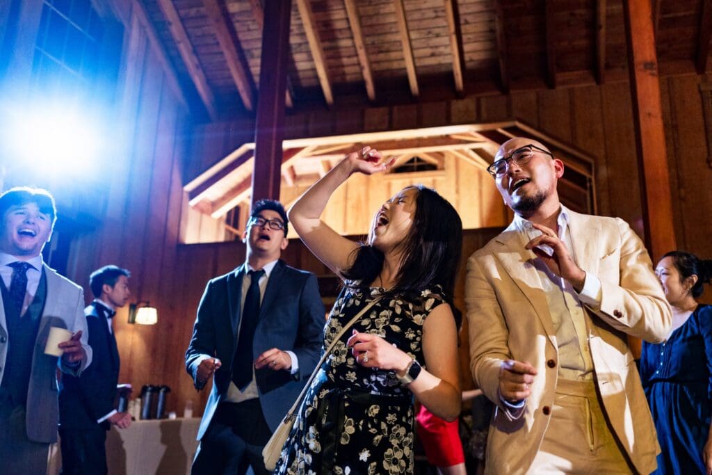 Wedding guests dancing and singing at wedding reception in Northern California