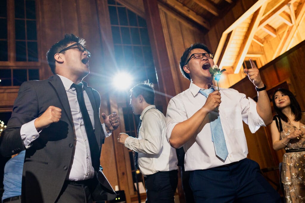 Wedding guests dancing and singing at wedding reception in Nestldown