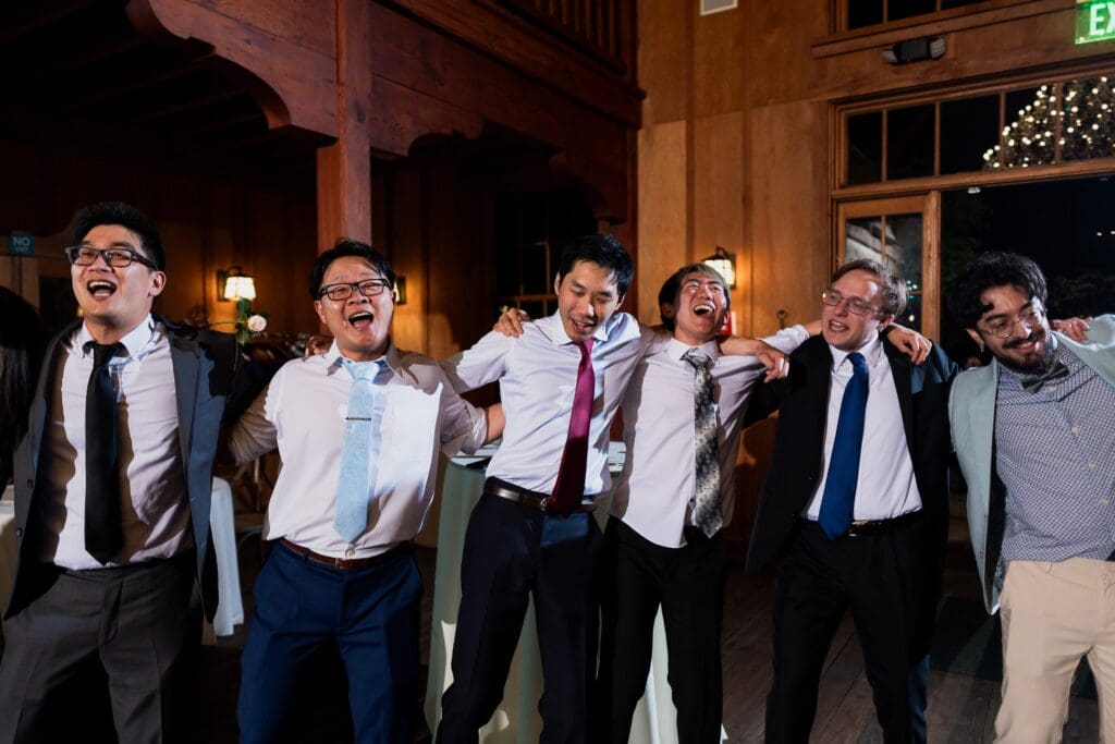Wedding party guests holding arms and dancing at Northern California wedding