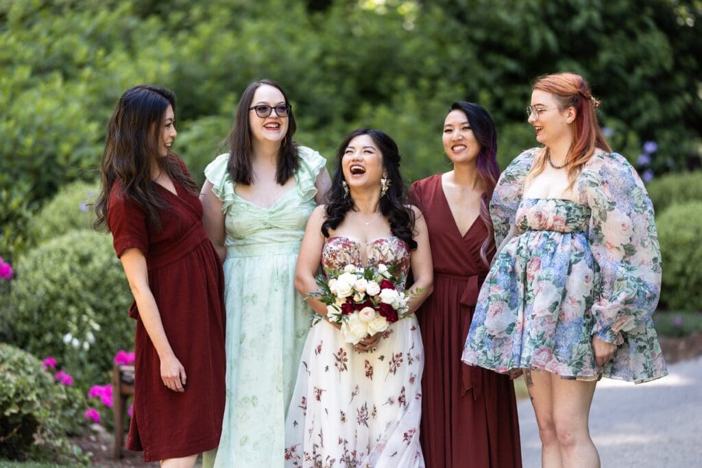 Bride laughing with bridesmaids at wedding reception in Nestldown