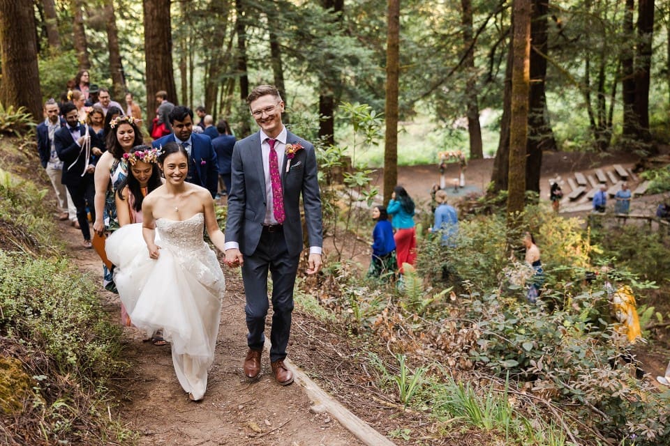 Bride and groom holding hands in outdoor wedding ceremony exit