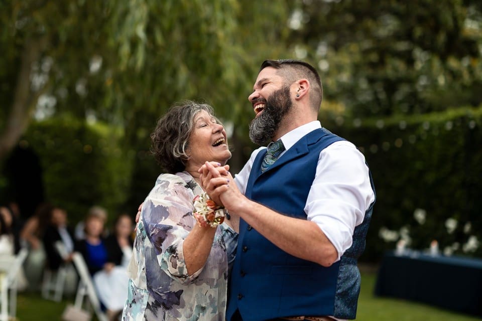 Groom and mother of the groom dancing and singing at first dance at Sonoma County Wedding