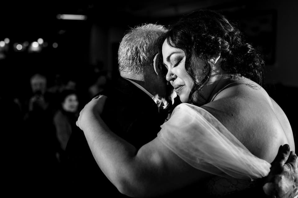 Black and white photo of bride hugging during first dance