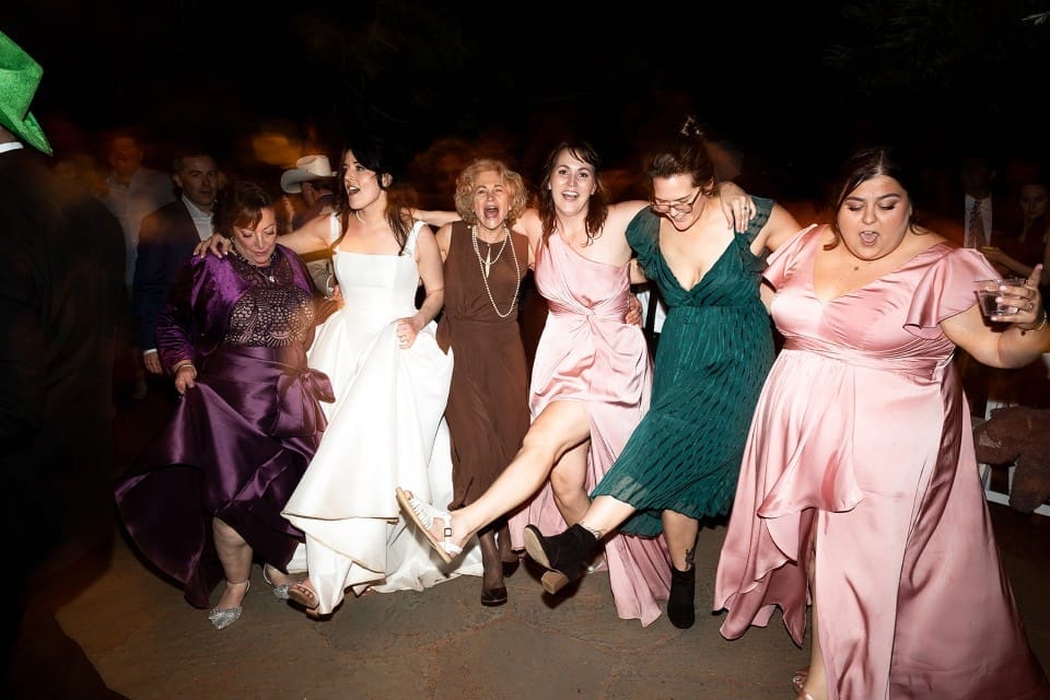 Bridesmaids and guests dancing with feet up at Northern California wedding