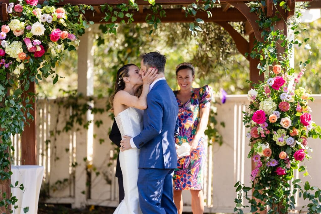 Bride and groom kissing at wedding ceremony at Flying Cloud Farm