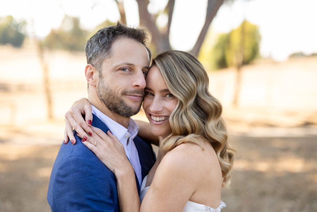 Bride and groom hugging at sunset photos at Northern California wedding venue
