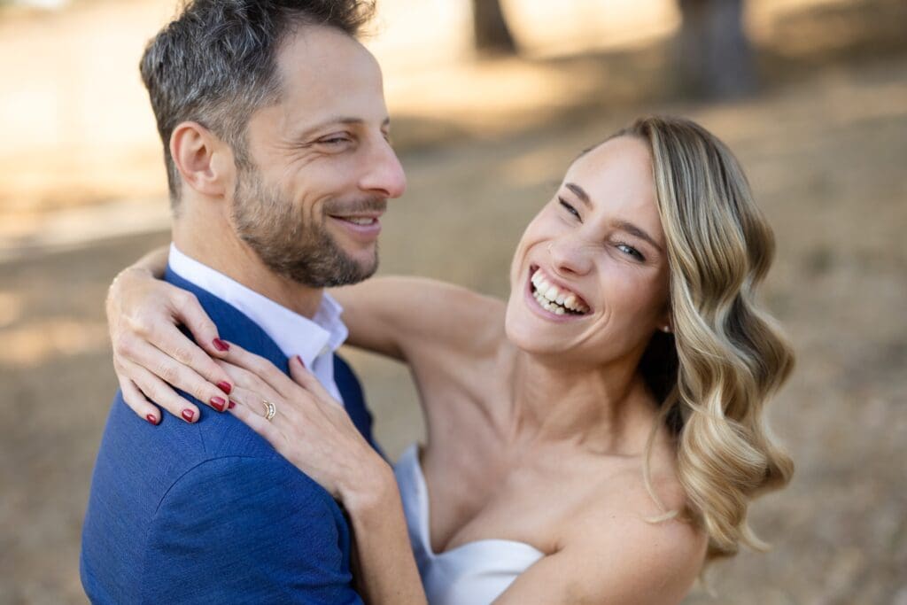 Bride and groom laughing and smiling for photos at Flying Cloud Farm
