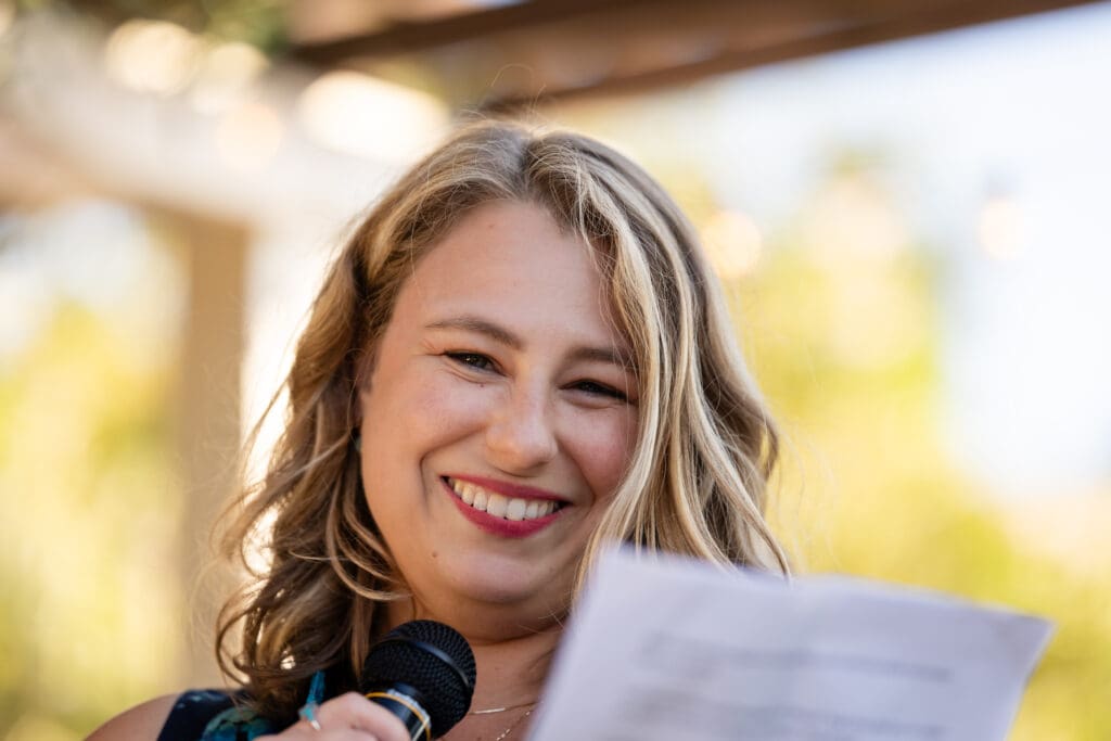 Woman reading words at wedding ceremony in Northern California