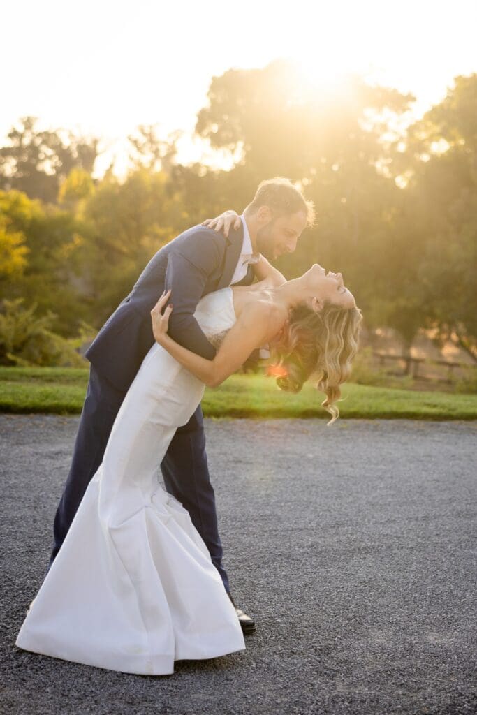 Sunset glow with bride and groom dancing and bride dipped at Flying Cloud Farm