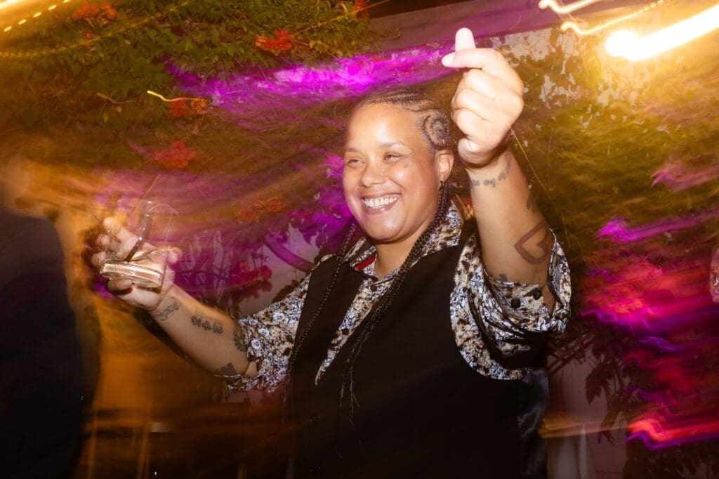 Wedding guest dancing and smiling at Flying Cloud Farm reception