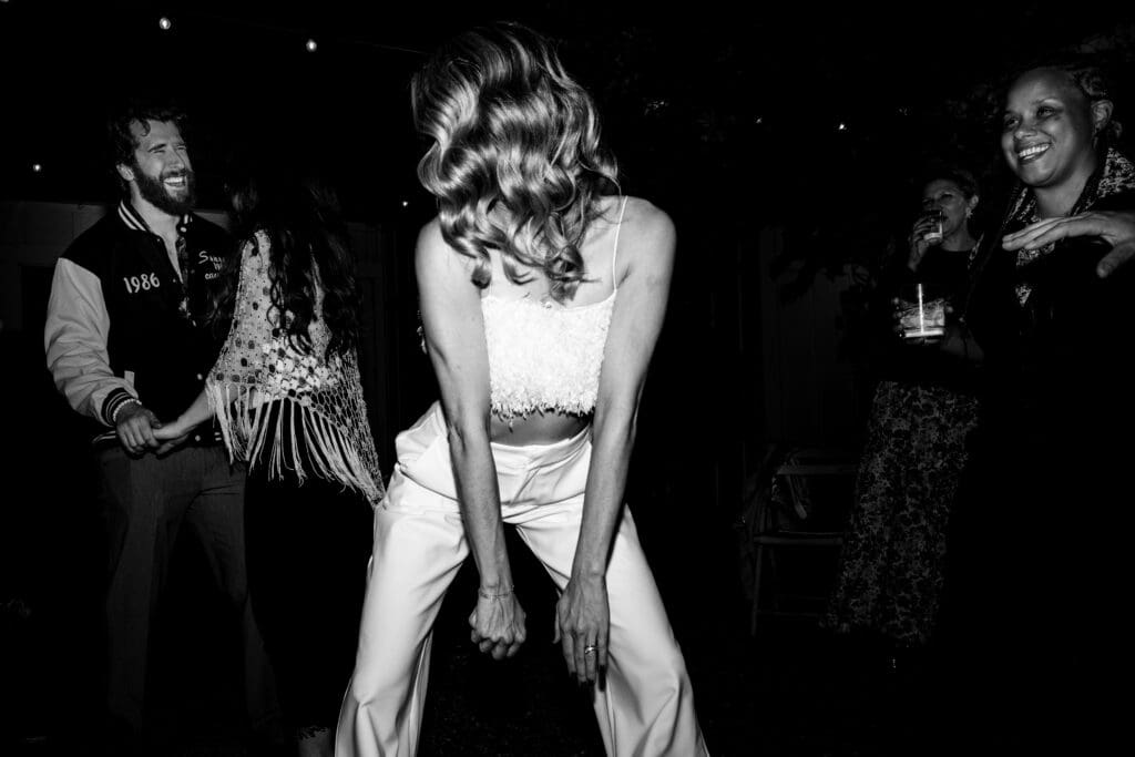 Black and white photo of bride dancing at Flying Cloud Farm