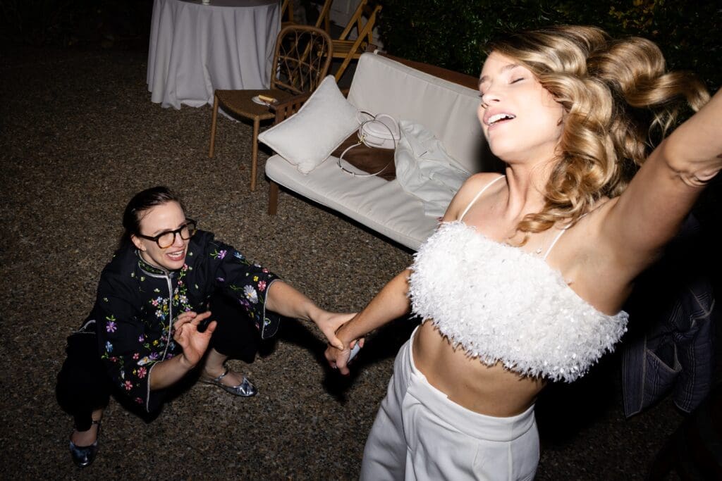 Bride dancing with wedding guest at Flying Cloud Farm
