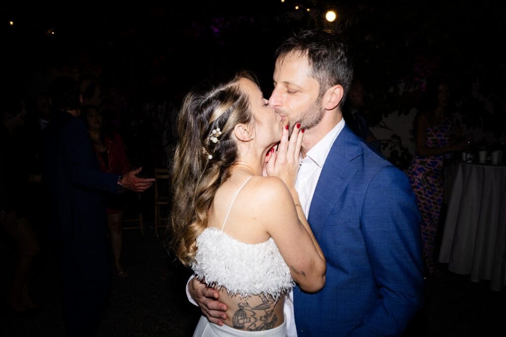 Bride and groom kissing at Flying Cloud Farm wedding reception