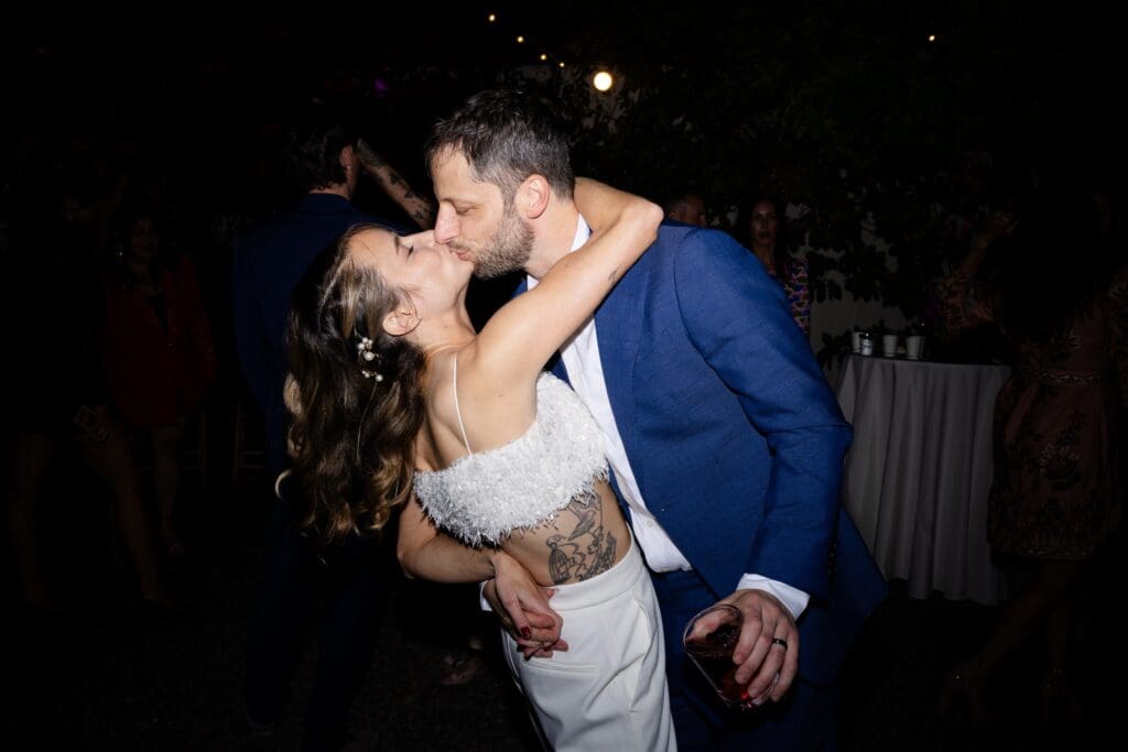 Bride and groom kissing on the dance floor at Flying Cloud Farm