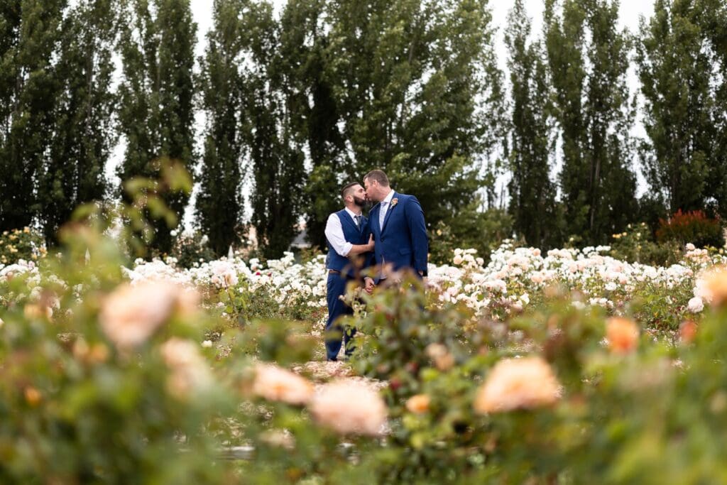 Garden Valley Ranch grooms kissing on the property