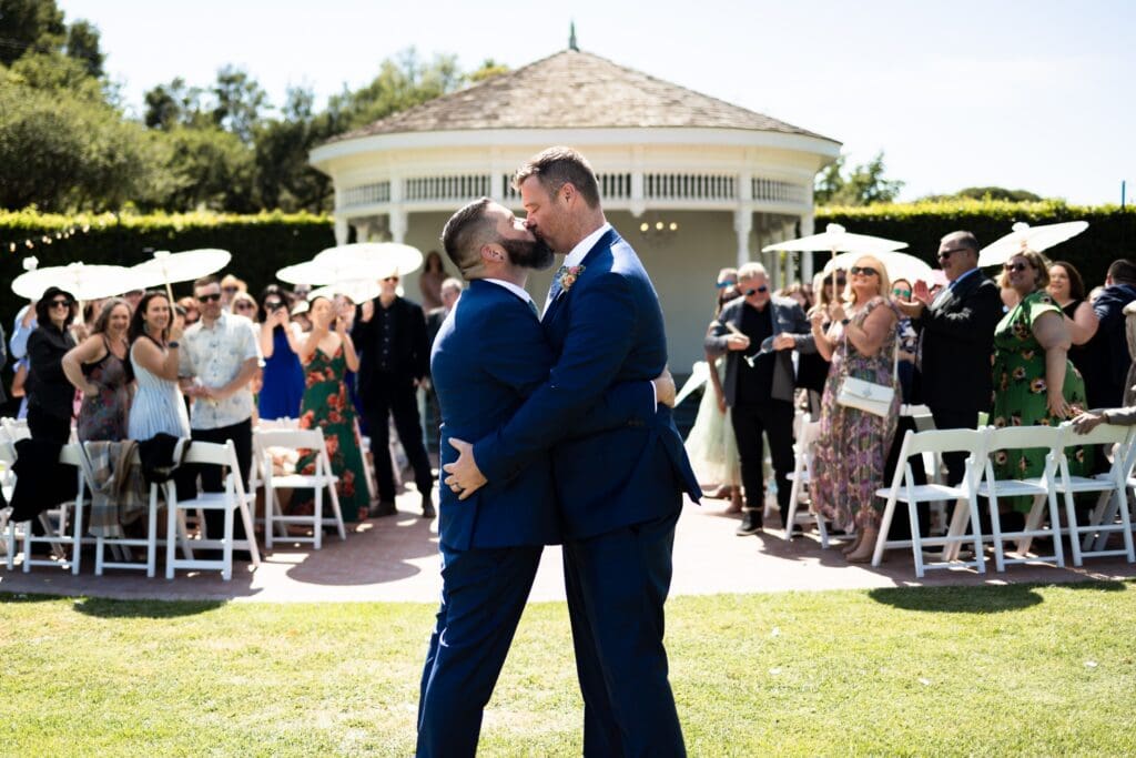 Grooms kissing after wedding ceremony in Garden Valley Ranch wedding