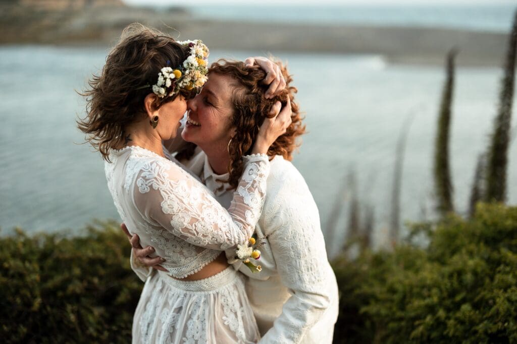 Brides kissing at Gualala Arts Center wedding reception