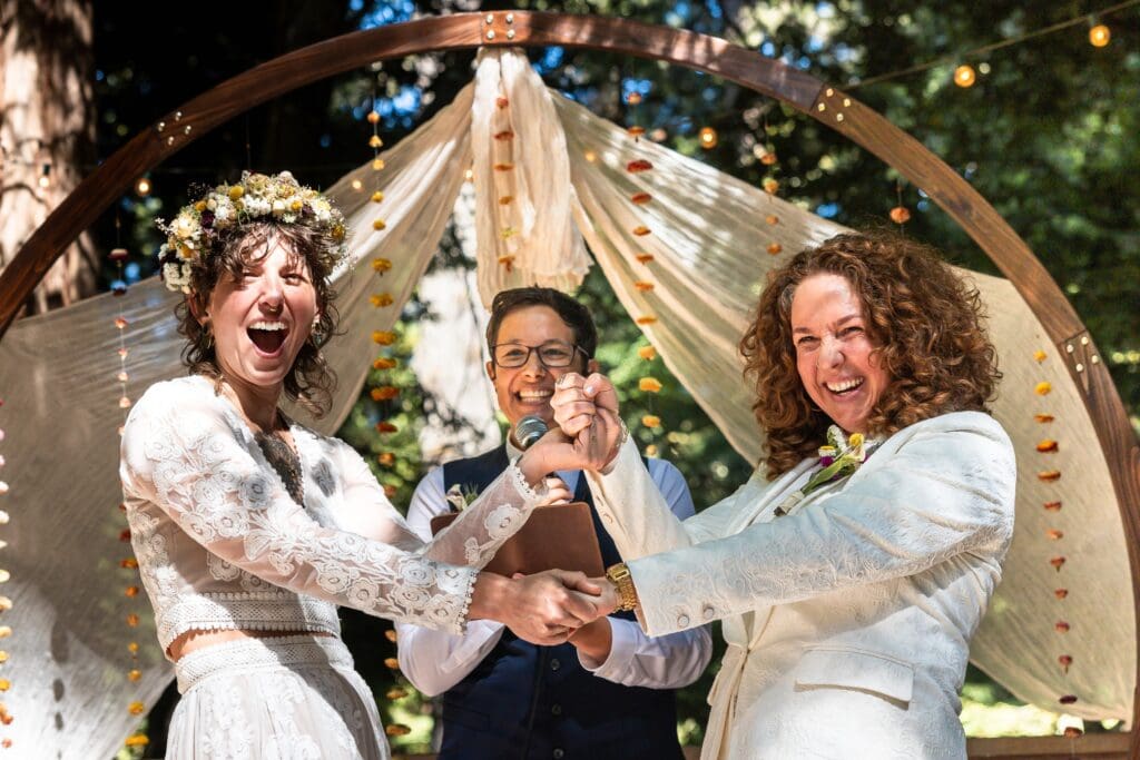 Brides laughing at Gualala Arts Center wedding ceremony