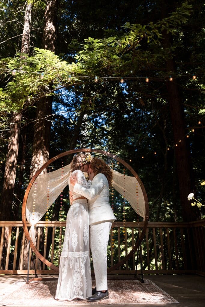 Brides kissing at Gualala wedding ceremony