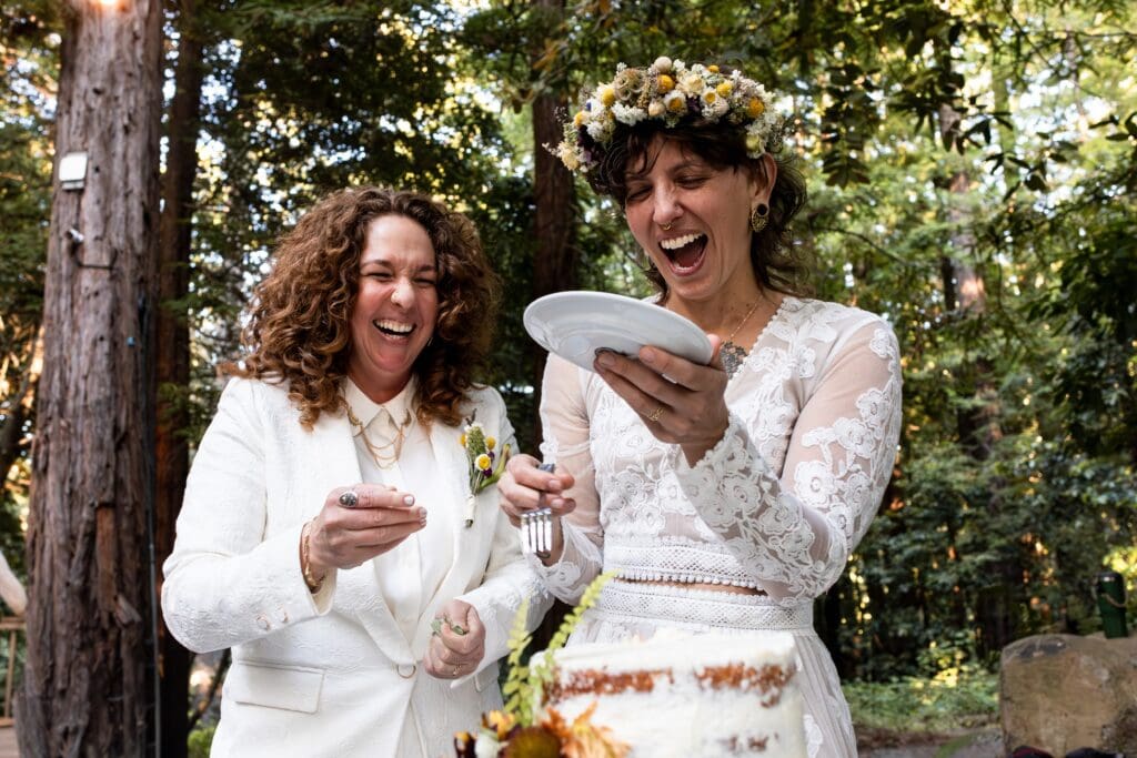Brides laughing at wedding ceremony in Gualala Arts Center