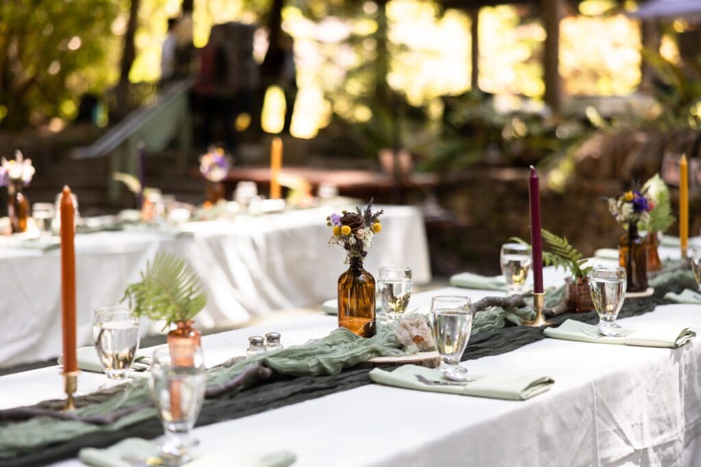 Wedding reception setup with flowers and tables at Gualala Arts Center
