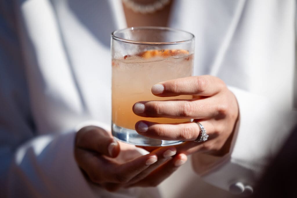 Bride holding on a drink at Fort Bragg wedding in California