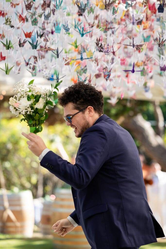 Bridal party member holding bouquet and sunglasses on at Fort Bragg wedding