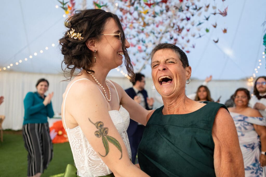 Bride and mother-of-bride laughing at Ft. Bragg wedding