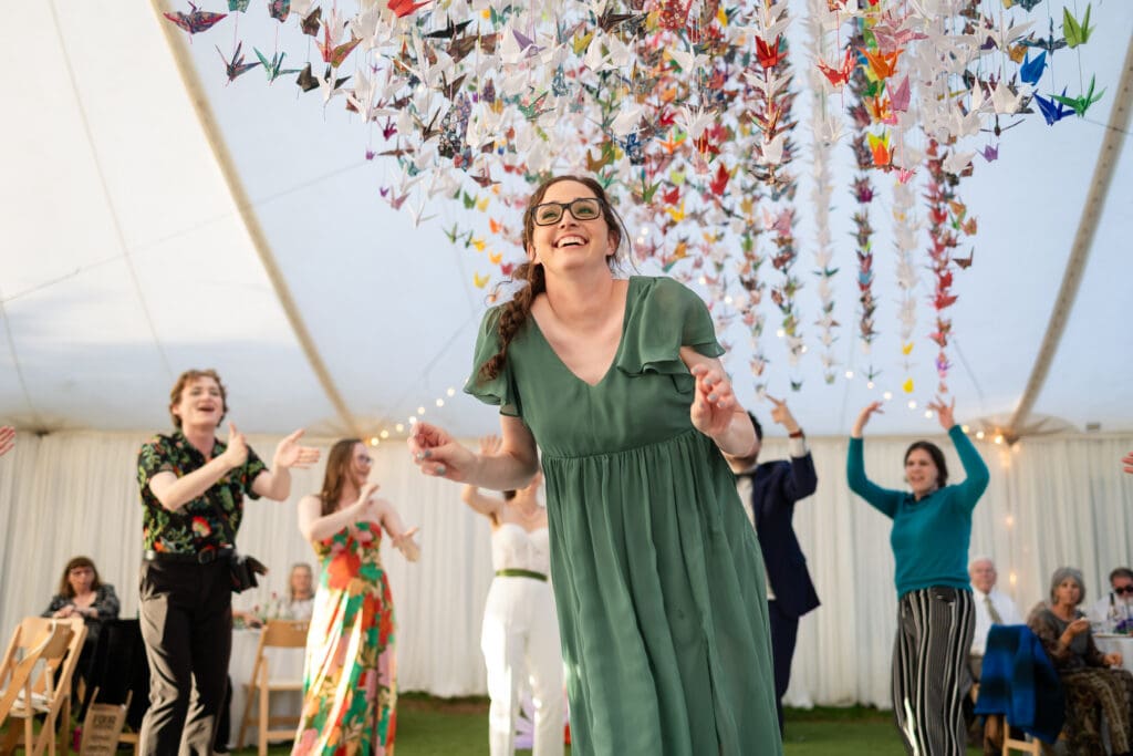 Wedding party smiling and dancing at Holly’s Ocean Meadow in Fort Bragg, CA